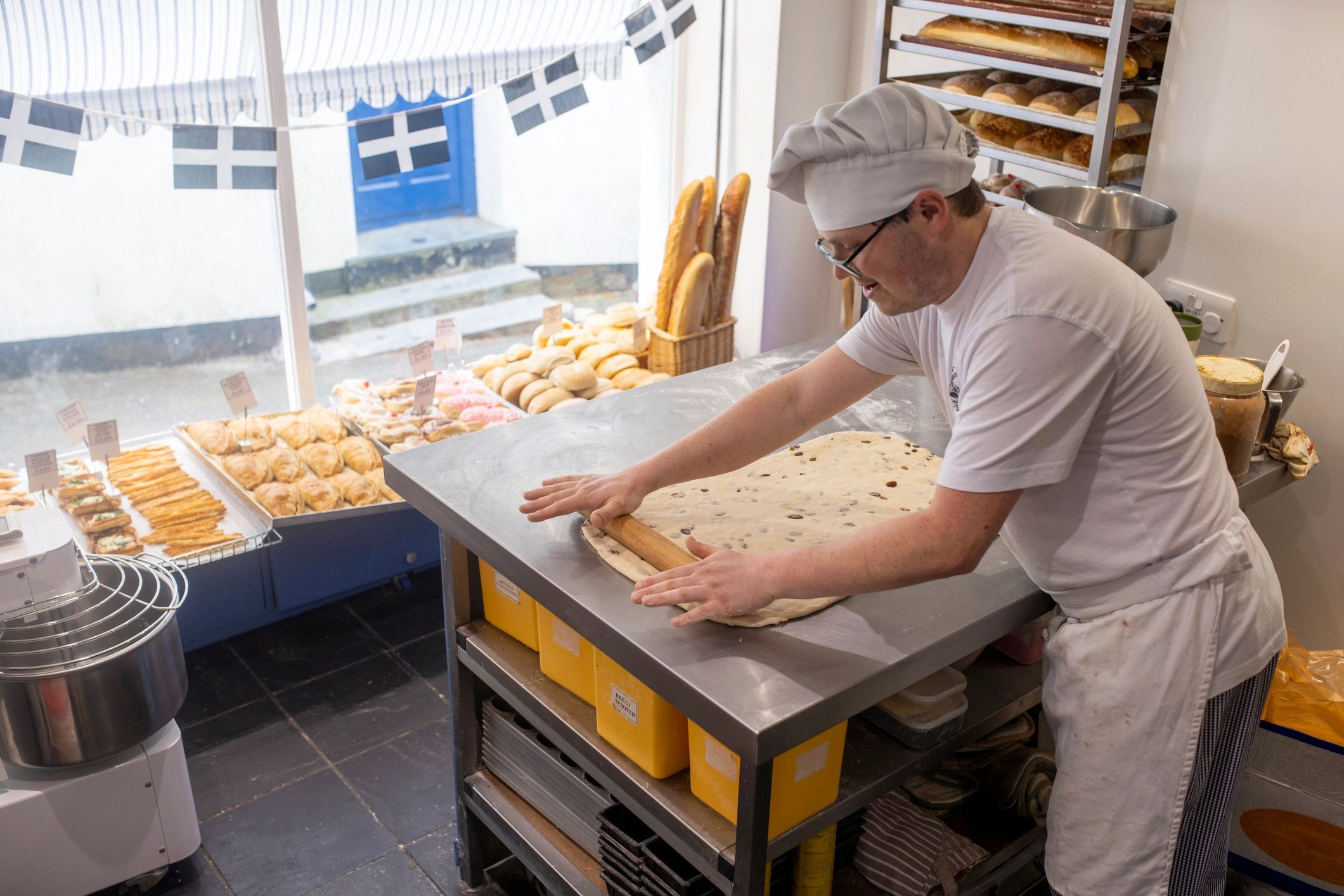 Chef preparing dough by hand in a professional kitchen